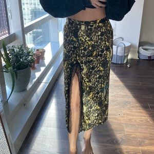 black and yellow print midi skirt with a lace slit. silky texture